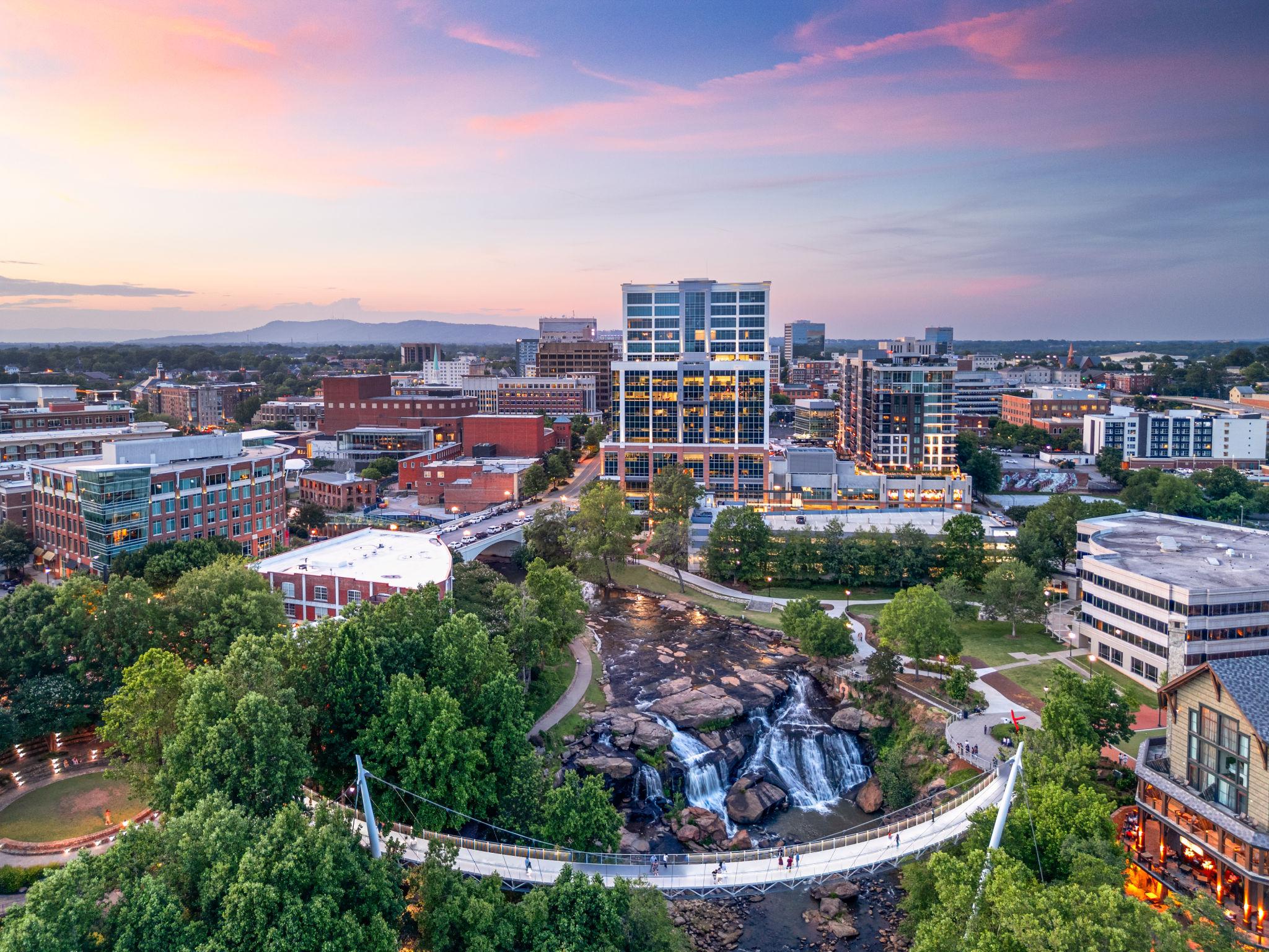 Downtown Greenville, South Carolina skyline at sunset with Falls Park and Liberty Bridge in the foreground